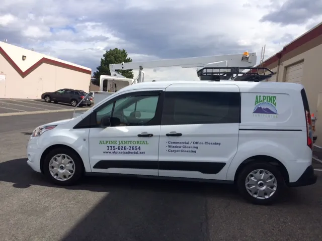 Alpine Janitorial service van parked at a Reno job site